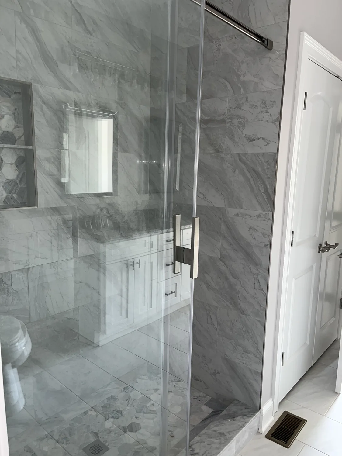 Tiled walk-in glass shower in an Old Silo Hill #2 condominium home